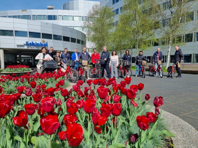 TULIPS partners op bikes in front of Schiphol with tulips